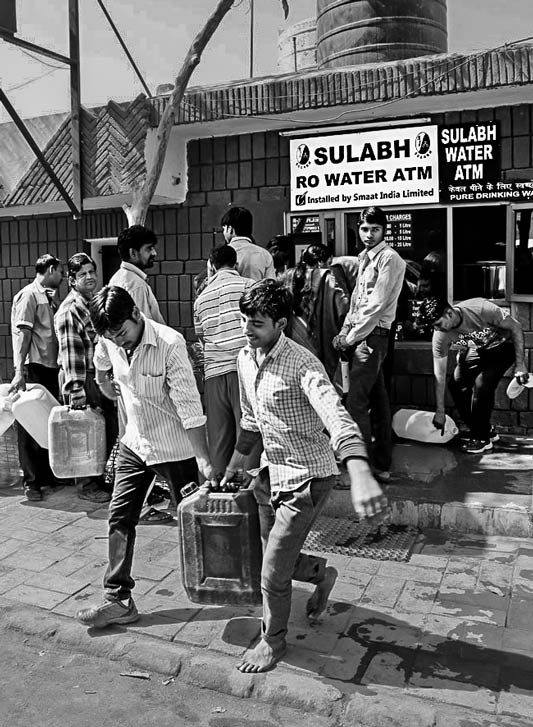 Local residents procuring safe drinking water from the Water ATM installed in Sulabh campus in South-West district, National Capital Territory of Delhi